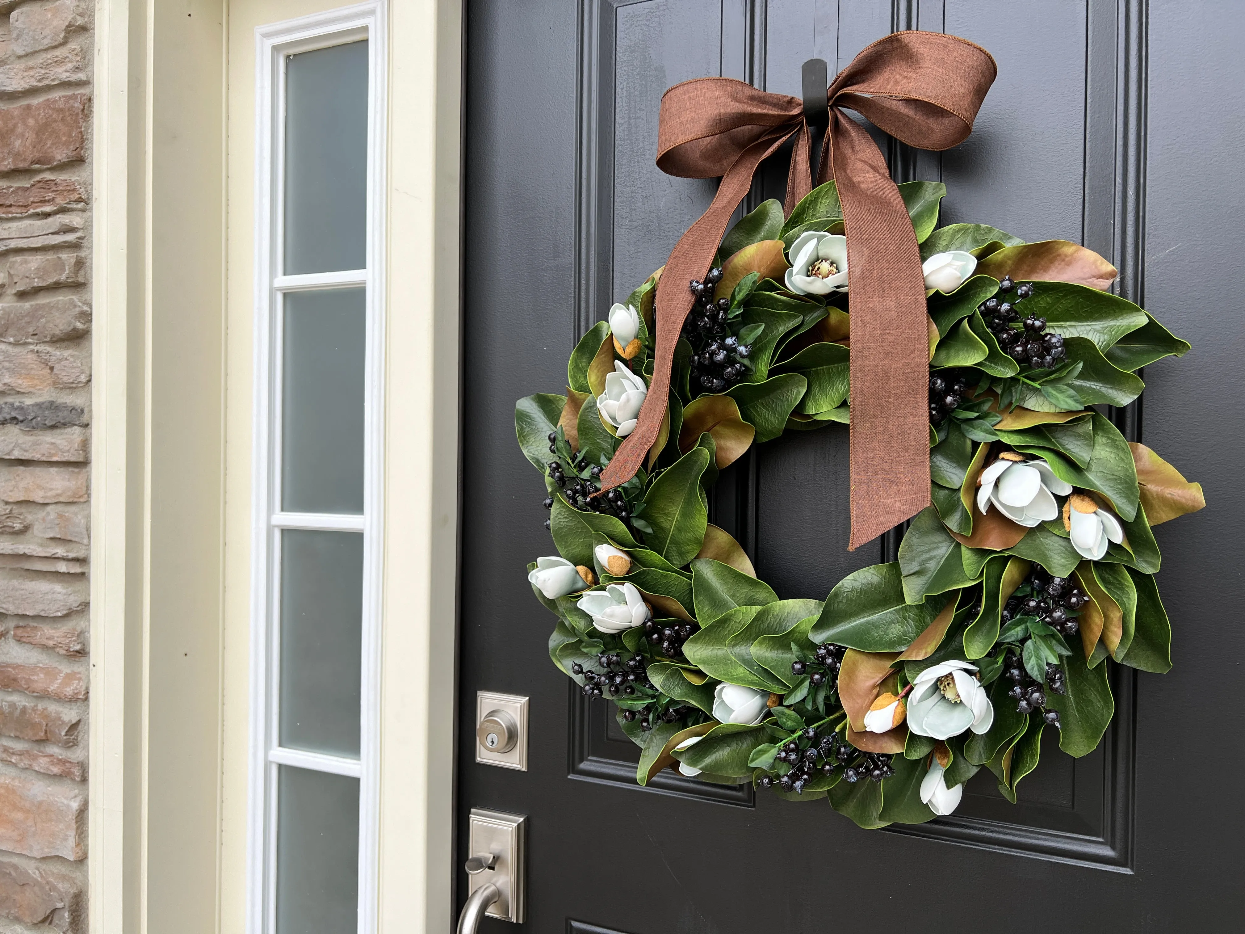 Blue Magnolia Wreath with Blue Berries and Brown Linen Ribbon